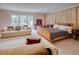 Bright bedroom featuring a large bed, a comfortable sofa, neutral colors and large glass doors at 1515 Park N St, St Petersburg, FL 33710