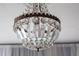 Close up of a vintage chandelier with cascading crystals and intricate bronze detailing adding elegance to the room at 1515 Park N St, St Petersburg, FL 33710