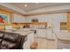 Bright kitchen with white cabinets, appliances, breakfast bar and a nice view to the living area at 1515 Park N St, St Petersburg, FL 33710