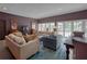Spacious living room with ample seating, dark paint, lots of light, and large windows at 1515 Park N St, St Petersburg, FL 33710