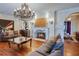 Cozy living room featuring a fireplace, chandelier and comfortable sofas at 1515 Park N St, St Petersburg, FL 33710