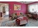 Charming living room featuring a classic patterned sofa and desk with natural lighting at 1515 Park N St, St Petersburg, FL 33710