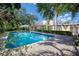 Backyard pool surrounded by a brick patio and lush landscaping, offering a tranquil and private outdoor retreat at 1515 Park N St, St Petersburg, FL 33710