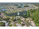 Aerial view of neighborhood featuring various ponds throughout the community and mature trees at 1613 Comfy Ct, Sun City Center, FL 33573