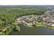 Aerial view featuring homes by the water surrounded by many trees at 1613 Comfy Ct, Sun City Center, FL 33573