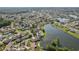 Aerial view featuring the neighborhood, several bodies of water, and mature trees at 1613 Comfy Ct, Sun City Center, FL 33573