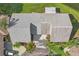 Aerial view of a single-story home featuring an open carport, manicured lawn, and a well-maintained roof at 1613 Comfy Ct, Sun City Center, FL 33573