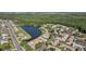 Aerial view of the neighborhood featuring ponds, landscaping and an adjacent road at 1613 Comfy Ct, Sun City Center, FL 33573