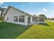 Backyard featuring a patio, screened lanai and a lush green lawn with lake view at 1613 Comfy Ct, Sun City Center, FL 33573