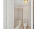 Bathroom with a tub/shower combination, accessible grab bar, and tiled walls at 1613 Comfy Ct, Sun City Center, FL 33573