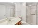 Clean bathroom with shower and grab bars, featuring a vanity with wood cabinets and mirror at 1613 Comfy Ct, Sun City Center, FL 33573