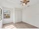 Bright bedroom featuring wood-look floors, ceiling fan and a window providing natural light at 1613 Comfy Ct, Sun City Center, FL 33573