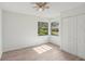 Bright bedroom with wood-look floors, closet and double windows at 1613 Comfy Ct, Sun City Center, FL 33573