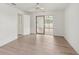 Bedroom with new flooring, a sliding door, and natural light at 1613 Comfy Ct, Sun City Center, FL 33573