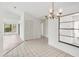 Bright dining area with tile flooring and modern chandelier at 1613 Comfy Ct, Sun City Center, FL 33573