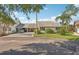 Charming single-story home with a driveway and carport, complemented by lush landscaping and manicured lawn at 1613 Comfy Ct, Sun City Center, FL 33573