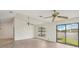 Living room with new flooring, ceiling fans, and sliding door to the outside at 1613 Comfy Ct, Sun City Center, FL 33573