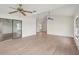 Open-concept living room with new flooring, ceiling fans, and large windows at 1613 Comfy Ct, Sun City Center, FL 33573