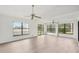 Bright living room with new flooring, ceiling fans, and lake views at 1613 Comfy Ct, Sun City Center, FL 33573