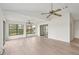 Spacious living room with new flooring, ceiling fans, and windows at 1613 Comfy Ct, Sun City Center, FL 33573