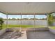 Enjoy serene lake views from this screened patio with tile flooring at 1613 Comfy Ct, Sun City Center, FL 33573