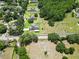 Aerial view of property and neighborhood showcasing home's serene, wooded setting and nearby amenities at 16220 Lake Armistead Way, Odessa, FL 33556