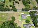 Aerial view of expansive grassy property featuring a home, pool, and several mature trees at 16220 Lake Armistead Way, Odessa, FL 33556