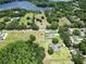 Beautiful aerial view of property with expansive yard, mature trees, and nearby lake at 16220 Lake Armistead Way, Odessa, FL 33556