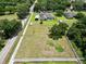 Aerial view of home, large backyard with pool, mature trees, and neighboring properties at 16220 Lake Armistead Way, Odessa, FL 33556