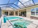 Backyard pool and patio is surrounded by a screened-in enclosure with an adjoining patio at 16220 Lake Armistead Way, Odessa, FL 33556