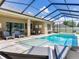 Backyard pool and patio surrounded by a screened-in enclosure with ample seating for entertaining at 16220 Lake Armistead Way, Odessa, FL 33556
