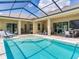 Backyard pool with screened-in enclosure and a spacious outdoor patio featuring ample seating at 16220 Lake Armistead Way, Odessa, FL 33556