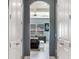 Arched doorway featuring bedroom with modern decor, tray ceilings, neutral tones, and natural light at 16220 Lake Armistead Way, Odessa, FL 33556