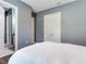 Bedroom featuring neutral gray walls, white double door closet, and ensuite bathroom at 16220 Lake Armistead Way, Odessa, FL 33556