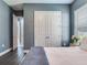 Bedroom with wood floors, double closet and neutral colored walls at 16220 Lake Armistead Way, Odessa, FL 33556