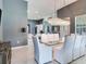 Dining room with a glass table and white chairs next to the kitchen area at 16220 Lake Armistead Way, Odessa, FL 33556