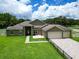 Charming single-story home with manicured lawn and fenced yard, complemented by a spacious driveway at 16220 Lake Armistead Way, Odessa, FL 33556