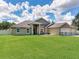 Lovely single-story home featuring a well-kept lawn, three-car garage, and secure fencing for privacy at 16220 Lake Armistead Way, Odessa, FL 33556