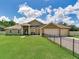 Beautiful single-story home with a well-manicured lawn and three-car garage, secured by an elegant fence at 16220 Lake Armistead Way, Odessa, FL 33556