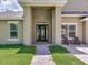 Welcoming front entrance with a decorative glass door and brick-paved walkway at 16220 Lake Armistead Way, Odessa, FL 33556
