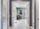 Hallway featuring access to another room with a desk, chair, and a sliding glass door at 16220 Lake Armistead Way, Odessa, FL 33556