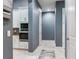 Hallway leading to kitchen area featuring neutral walls, tiled floors, and built in microwave at 16220 Lake Armistead Way, Odessa, FL 33556