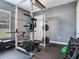 Home gym with workout equipment including weights and a Rogue power rack at 16220 Lake Armistead Way, Odessa, FL 33556