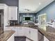 Kitchen featuring stainless steel appliances, granite countertops, white cabinetry and open to the Gathering room at 16220 Lake Armistead Way, Odessa, FL 33556