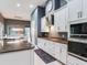 Bright kitchen featuring white cabinets, modern appliances, granite countertops, and an open layout dining area at 16220 Lake Armistead Way, Odessa, FL 33556