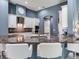 Modern kitchen with white cabinets, stainless steel appliances, and an oversized island at 16220 Lake Armistead Way, Odessa, FL 33556