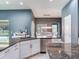 Kitchen with stainless steel appliances, granite countertops, white cabinetry and views of the pool and dining area at 16220 Lake Armistead Way, Odessa, FL 33556