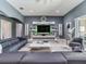 Sleek living space with a modern entertainment unit and sliding glass doors in neutral tones at 16220 Lake Armistead Way, Odessa, FL 33556