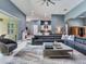 Open-concept living room with gray sectional sofa and view of kitchen at 16220 Lake Armistead Way, Odessa, FL 33556