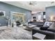 Inviting living room featuring a gray sectional and sliding glass doors to the patio at 16220 Lake Armistead Way, Odessa, FL 33556